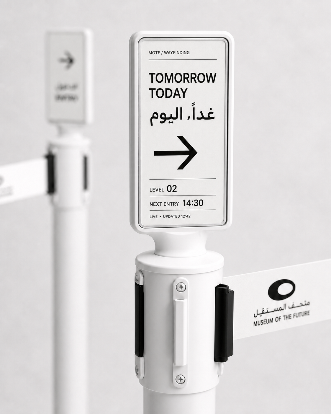 Close-up render of a slim vertical e-paper display mounted on an existing Museum of the Future retractable-belt stanchion